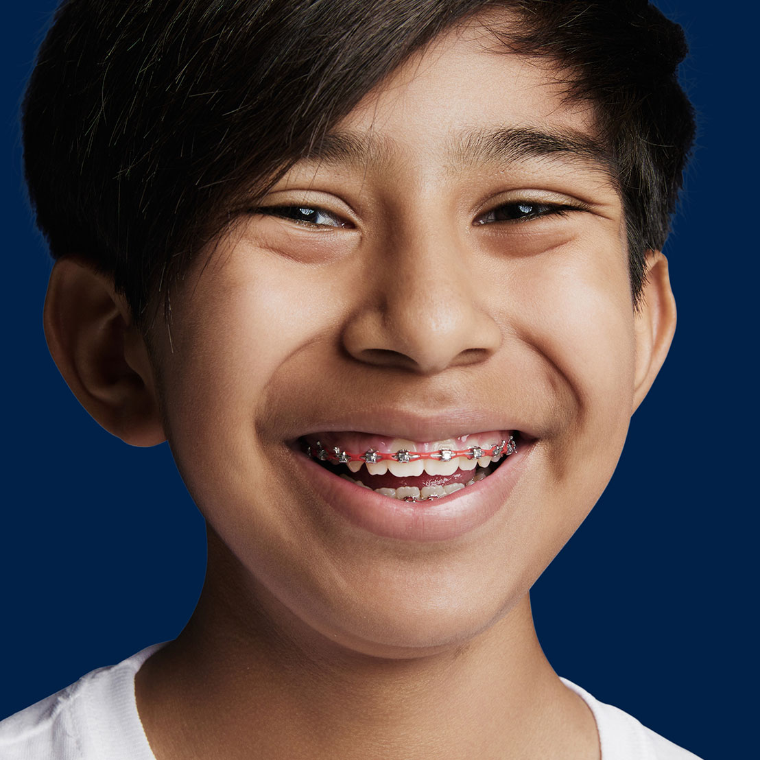 image of young teen with metal braces smiling