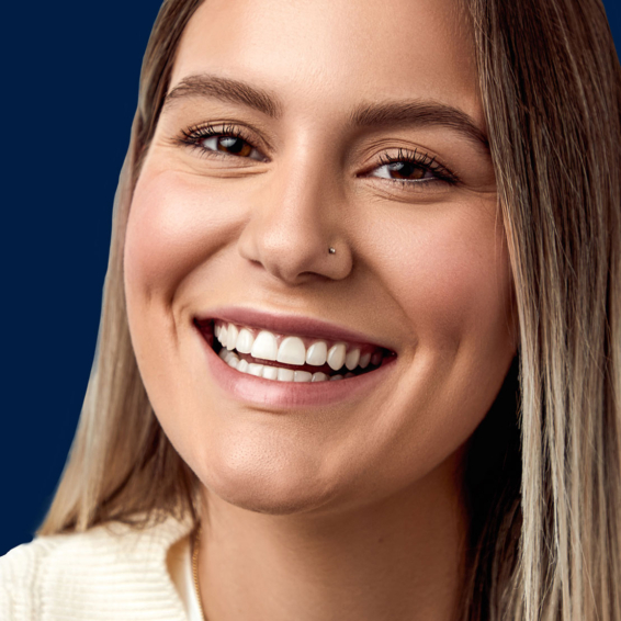 image of young woman wearing invisalign aligners smiling