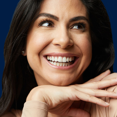 woman smiling wearing clear aligners